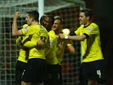Troy Deeney of Watford celebrates with team mates as he scores their second goal during the Sky Bet Championship match between Watford and Rotherham United at Vicarage Road on February 24, 2015