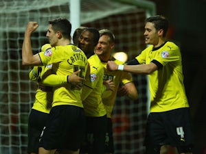 Troy Deeney of Watford celebrates with team mates as he scores their second goal during the Sky Bet Championship match between Watford and Rotherham United at Vicarage Road on February 24, 2015