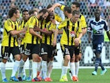 Rolieny Bonevacia of the Phoenix is congratulated by team mates after scoring a goal during the round 19 A-League match between the Melbourne Victory and the Wellington Phoenix at AAMI Park on March 1, 2015
