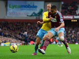 Winston Reid of West Ham United battles with Glenn Murray of Crystal Palace during the Barclays Premier League match between West Ham United and Crystal Palace at Boleyn Ground on February 28, 2015