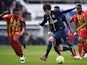 Paris Saint-Germain's French midfielder Adrien Rabiot (C) advances with the ball past Lens' French defender Loick Landre (L) during the French L1 football match  on March 7, 2015