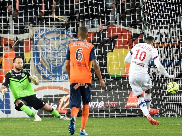 Lyon's French forward Alexandre Lacazette (R) scores from a penalty during the French L1 football match between Montpellier and Lyon, on March 8, 2015