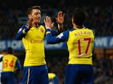 Alexis Sanchez of Arsenal (17) celebrates with Mesut Ozil as he scores their second goal during the Barclays Premier League match on  March 4, 2015