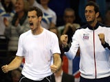 Britain's Andy Murray (L) and James Ward cheer as their teammates Britain's Dominic Inglot and Jamie Murray compete against Mike Bryan and Bob Bryan of US (not pictured) during the Davis Cup match on March 7, 2015