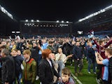 Aston Villa fans celebrate victory on the pitch after the FA Cup Quarter Final match between Aston Villa and West Bromwich Albion at Villa Park on March 7, 2015