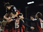 Steve Cook of Bournemouth is mobbed by team mates as he celebrates scoring their fifth goal during the Sky Bet Championship match between Fulham and AFC Bournemouth at Craven Cottage on March 6, 2015