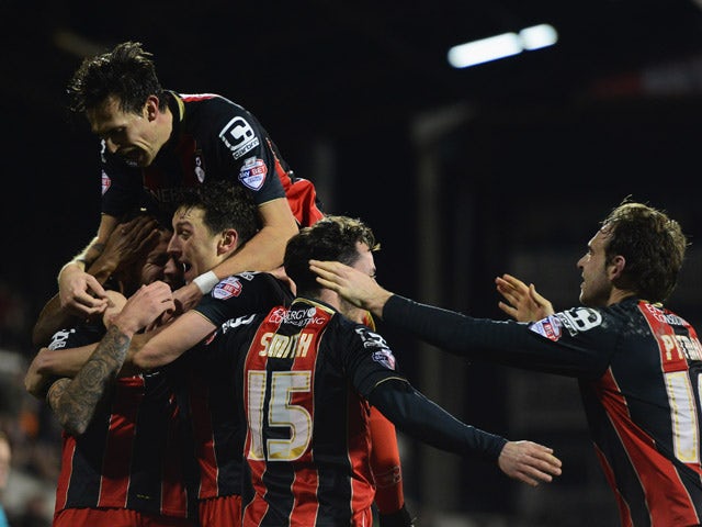 Steve Cook of Bournemouth is mobbed by team mates as he celebrates scoring their fifth goal during the Sky Bet Championship match between Fulham and AFC Bournemouth at Craven Cottage on March 6, 2015