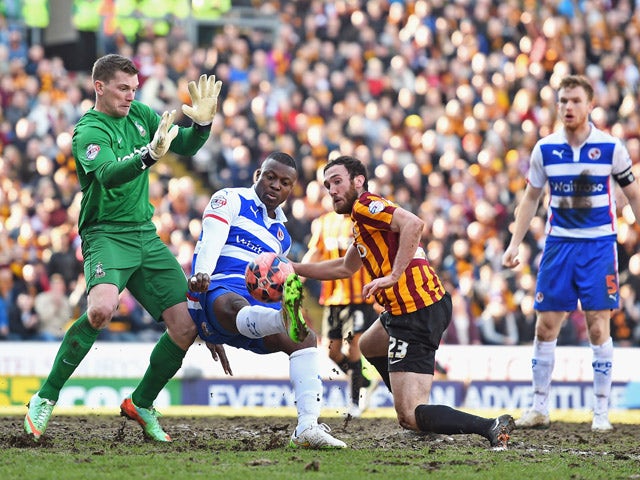Yakubu Aiyegbeni of Reading is closed down by goalkeeper Ben Williams of Bradford City and Rory McArdle of Bradford City during the FA Cup Quarter Final match between Bradford City and Reading at the Coral Windows Stadium, Valley Parade on March 7, 2015