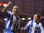 Porto's Costinha (L) celebrates as teammate Maniche joins hime after scoring against Manchester United in the final minute of a Champions League tie on March 9, 2004