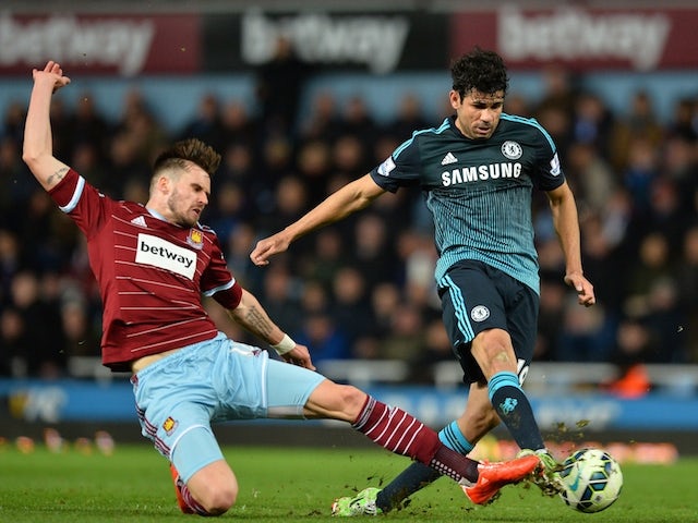 Chelsea's Brazilian-born Spanish striker Diego Costa (R) has an unsuccessful shot under pressure from West Ham United's English defender Carl Jenkinson on March 3, 2015