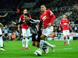 Manchester United player Chris Smalling (r) challenges Emmanuel Riviere of Newcastle in the penalty area during the Barclays Premier League match