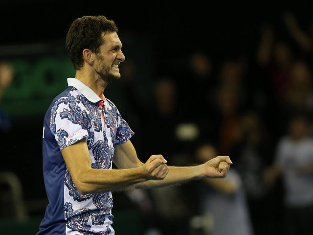 Great Britain's James Ward celebrates after winning his Davis Cup World Group first-round singles tennis match 6-7 (4/7), 5-7, 6-3, 7-6 (7/3), 15-13, against John Isner of US at The Emirates Arena in Glasgow, Scotland, on March 6, 2015