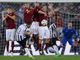 Juventus' Argentine forward Carlos Tevez shoots a free kick and scores a goal during the Italian Serie A football match between AS Roma and Juventus at the Olympic Stadium in Rome on March 2, 2015