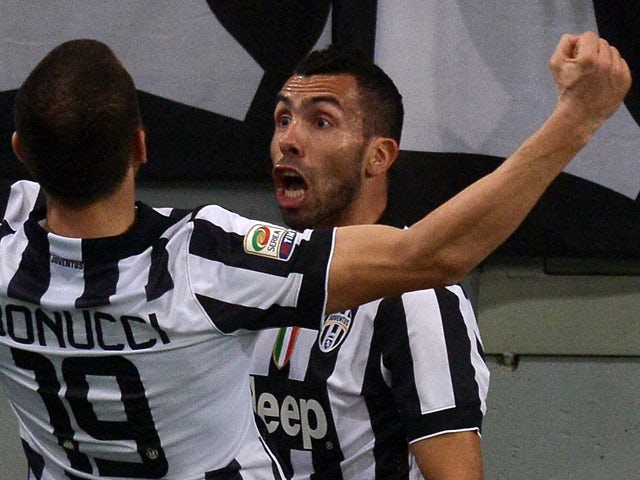 Juventus' Argentine forward Carlos Tevez celebrates after scoring a goal during the Italian Serie A football match between AS Roma and Juventus at the Olympic Stadium in Rome on March 2, 2015