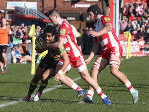 Ken Pisi of Northampton is knocked into touch by Jonny May during the Aviva Premiership match between Gloucester and Northampton Saints at Kingsholm Stadium on March 7, 2015