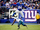 Larry Donnell #84 of the New York Giants jumps over Jaylen Watkins #37 of the Philadelphia Eagles in the third quarter during a game at MetLife Stadium on December 28, 2014