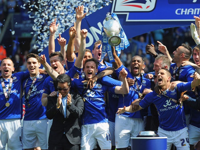 Wes Morgan of Leicester City lifts the Championship trophy after the Sky Bet Championship match between Leicester City and Doncaster Rovers at The King Power Stadium on May 3, 2014