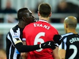 Manchester United player Jonny Evans looks on as Papiss Cisse of Newcastle appears to spit during the Barclays Premier League match between Newcastle United and Manchester United at St James' Park on March 4, 2015