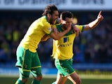 Jonathan Howson of Norwich celebrates with team mate Bradley Johnson after he scores the first goal of the game during the Sky Bet Championship match between Millwall and Norwich City at The Den on March 07, 2015