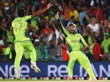 Wahab Riaz of Pakistan celebrates with Ahmad Shahzad of Pakistan after claiming the last wicket of Imran Tahir of South Africa to win the 2015 ICC Cricket World Cup match between South Africa and Pakistan at Eden Park on March 7, 2015