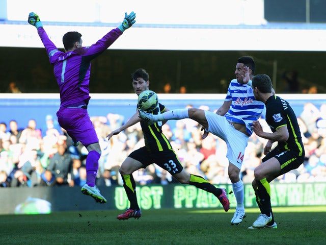 Mauricio Isla of QPR is faced by goalkeeper Hugo Lloris of Spurs during the Barclays Premier League match between Queens Park Rangers and Tottenham Hotspur at Loftus Road on March 7, 2015