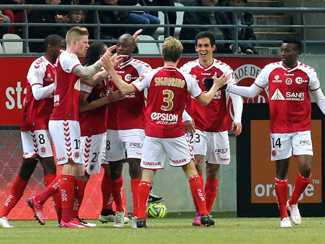Reims' teammates celebrate after Reims' French Algerian defender Aissa Mandi scored a goal during the French Football match Reims vs Nantes, on March 7, 2015 