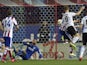 Valencia's German defender Shkodran Mustafi (R) heads a ball and scores during the Spanish league football match against Atletico Madrid on March 8, 2015