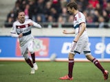 Bayern Munich's forward Thomas Mueller (R) celebrates scoring a penalty goal during the German first division Bundesliga football match against Hanover 96 on March 7, 2015