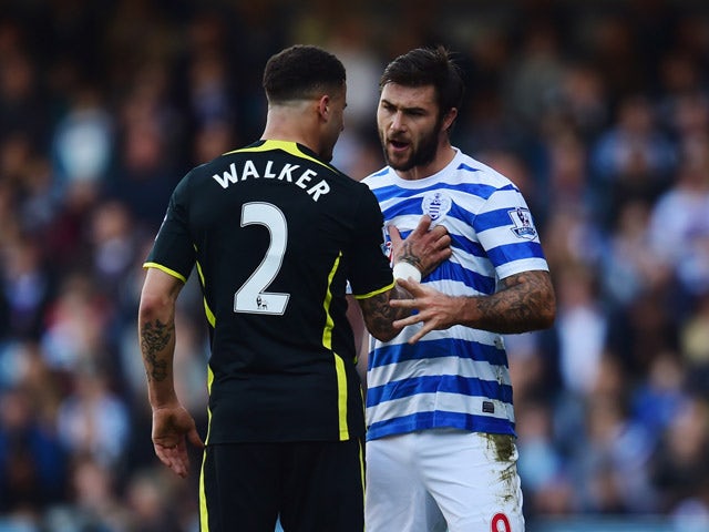 Kyle Walker of Spurs and Charlie Austin of QPR argue during the Barclays Premier League match between Queens Park Rangers and Tottenham Hotspur at Loftus Road on March 7, 2015