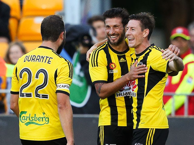 Andrew Durante and Vince Lia of the Phoenix congratulate teammate Nathan Burns on his goal during the round 20 A-League match between the Wellington Phoenix and Adelaide United at Hutt Recreation Ground on March 7, 2015
