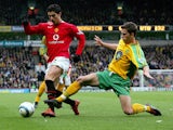 Norwich City's Adam Drury attempts to tackle Manchester United's Cristiano Ronaldo at the Carrow Road stadium 09 April 2005