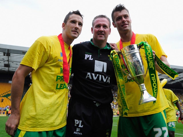 Manager of Norwich City Paul Lambert, Adam Drury and Elliot Ward celebrates promotion during the npower Championship match between Norwich City and Coventry City at Carrow Road on May 7, 2011 
