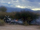 Picture of the burning wreckages of two helicopters which collided mid-air near Villa Castelli, in the Argentine province of La Rioja, on March 9, 2015