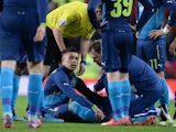 Arsenal's English midfielder Alex Oxlade-Chamberlain receives treatment after picking up an injury during the FA Cup quarter-final football match between Manchester United and Arsenal at Old Trafford in Manchester, north west England, on March 9, 2015