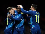Danny Welbeck of Arsenal celebrates with teammates Hector Bellerin and Mesut Ozil of Arsenal after scoring his team's second goal during the FA Cup Quarter Final match between Manchester United and Arsenal at Old Trafford on March 9, 201