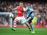 Matthew Jarvis of West Ham United is closed down by Calum Chambers of Arsenal during the Barclays Premier League match between Arsenal and West Ham United at Emirates Stadium on March 14, 2015