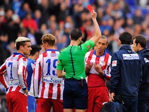 Joao Miranda of Atletico de Madrid is shown a red card for a challenge on Abraham Gonzalez of RCD Espanyol during the La Liga match between RCD Espanyol and Club Atletico de Madrid at Power 8 Stadium on March 14, 2015