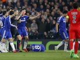 Dutch referee Bjorn Kuipers gives the red card to Paris Saint-Germain's Swedish forward Zlatan Ibrahimovic following a clash with Chelsea's Brazilian midfielder Oscar (Below L) during the UEFA Champions League round of 16 second leg football match between
