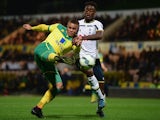 Carlton Morris of Norwich City battles with Christian Maghoma of Spurs during the Barclays U21 Premier League match between Norwich City U21 and Tottenham Hotspur U21 at Carrow Road on October 14, 2014