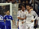 Real Madrid's Portuguese forward Cristiano Ronaldo (R) is congratulated by Fabio Coentrao (C) during the UEFA Champions League round of 16 match against Schalke on March 10, 2015