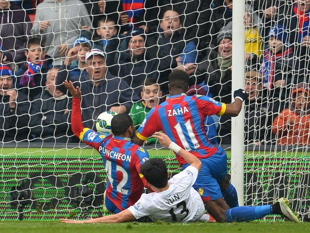 Crystal Palace's Ivorian-born English striker Wilfried Zaha falls as he aims to score the opening goal during the English Premier League football match between Crystal Palace and Queens Park Rangers at Selhurst Park in London on March 14, 2015