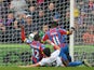 Crystal Palace's Ivorian-born English striker Wilfried Zaha falls as he aims to score the opening goal during the English Premier League football match between Crystal Palace and Queens Park Rangers at Selhurst Park in London on March 14, 2015