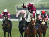 Bryan J. Cooper celebrates on Don Poli as they win the RSA Chase during Ladies Day at the Cheltenham Festival at Cheltenham Racecourse on March 11, 2015