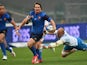 France's fly-half Camille Lopez escapes from Italy's Sergio Parisse during the Six Nations international rugby union match between Italy and France on March 15, 2015