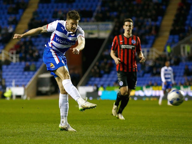 Jamie Mackie of Reading scoresl during the Sky Bet Championship match between Reading and Brighton & Hove Albion at Madejski Stadium on March 10, 2015