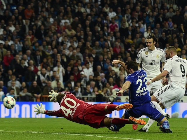 Real Madrid's French forward Karim Benzema kicks and scores against Schalke during the Champions League match on March 10, 2015