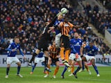 Mark Schwarzer of Leicester City punches the ball clear of Dame N'Doye of Hull and Ritchie De Laet of Leicester City during the Barclays Premier League match between Leicester City and Hull City at The King Power Stadium on March 14, 2015