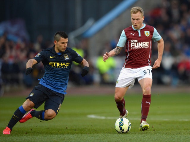 Sergio Aguero of Manchester City marshalls Scott Arfield of Burnley during the Barclays Premier League match between Burnley and Manchester City at Turf Moor on March 14, 2015