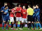 Angel di Maria of Manchester United remonstrates with referee Michael Oliver as he receives the yellow card during the FA Cup Quarter Final match between Manchester United and Arsenal at Old Trafford on March 9, 2015