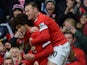 Manchester United's Belgian midfielder Marouane Fellaini celebrates with Manchester United's English striker Wayne Rooney after scoring the opening goal of the English Premier League football match between Manchester United and Tottenham Hotspur at Old Tr